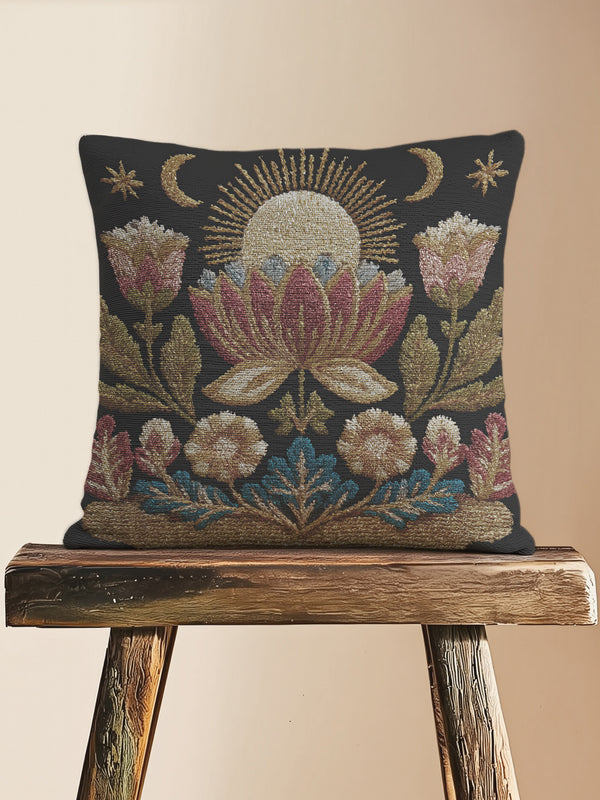 Woven tapestry pillow, 17" x 18", showcasing a radiant sun above a lotus with crescent moons and florals in gold, berry, and teal on black. Artisan-woven 58% cotton, 42% polyester; stuffed with soft polyfill. Sewn-shut construction; pattern duplicated on both sides. Luxe, symbolic woven pillow for celestial décor, dark-academia styling, and enchanting living spaces.